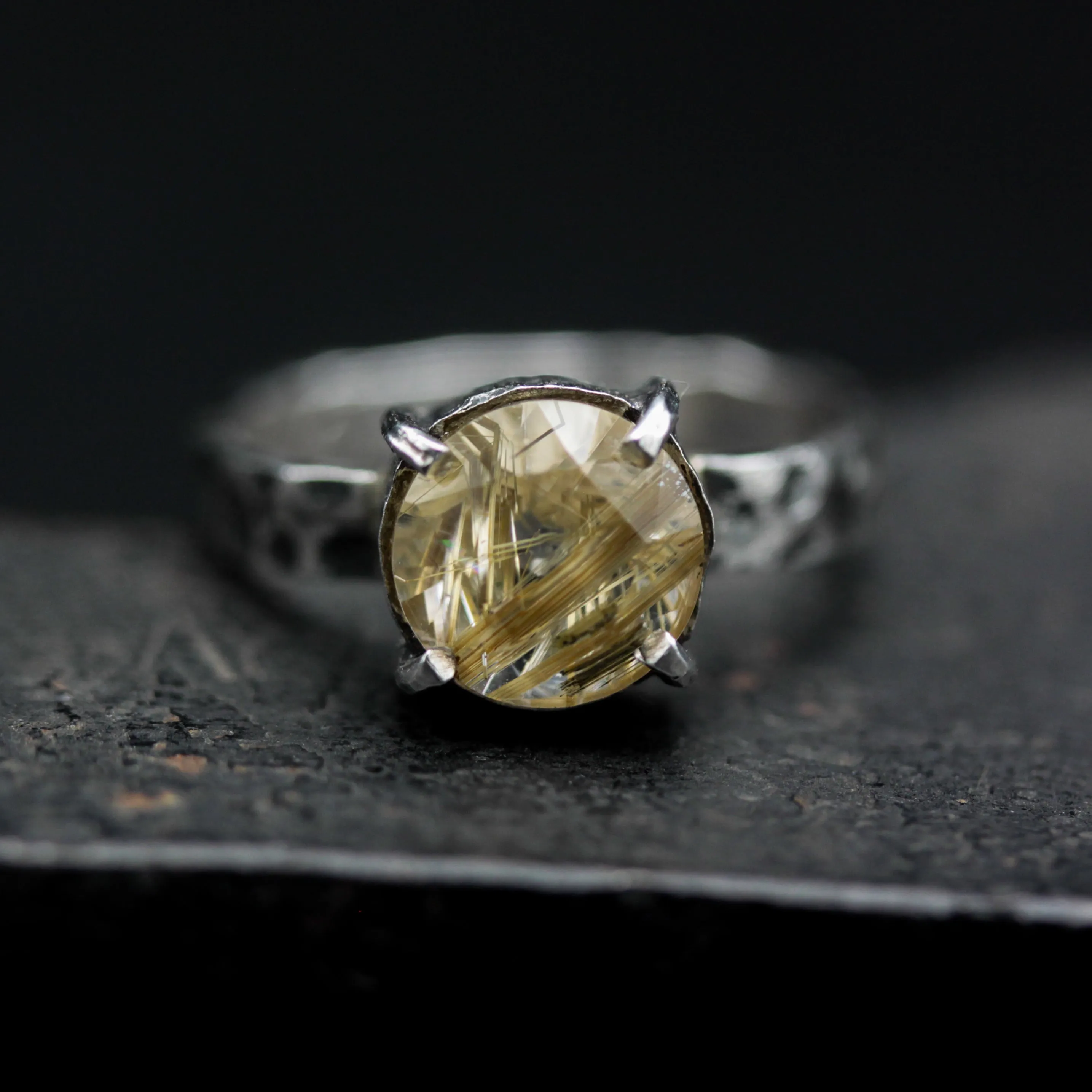 Round faceted golden rutilated quartz ring in silver bezel and prongs setting with sterling silver texture oxidized band