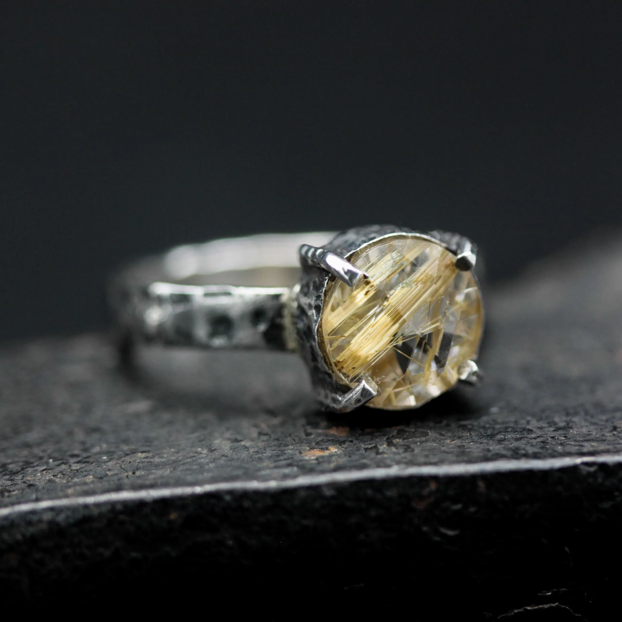 Round faceted golden rutilated quartz ring in silver bezel and prongs setting with sterling silver texture oxidized band